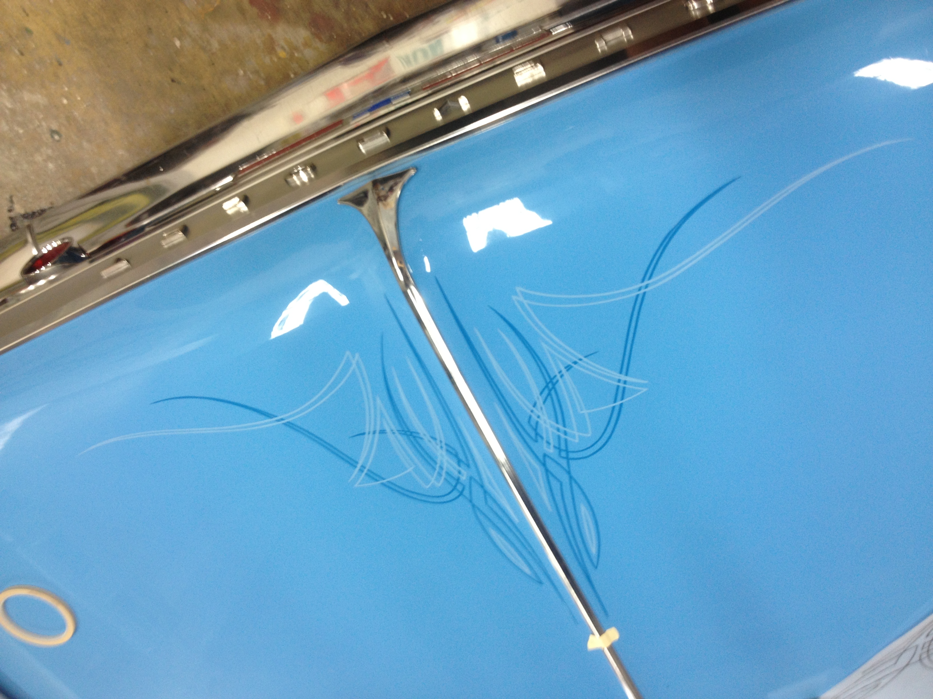 Hand-drawn pinstripe layout sketched on a car hood before painting