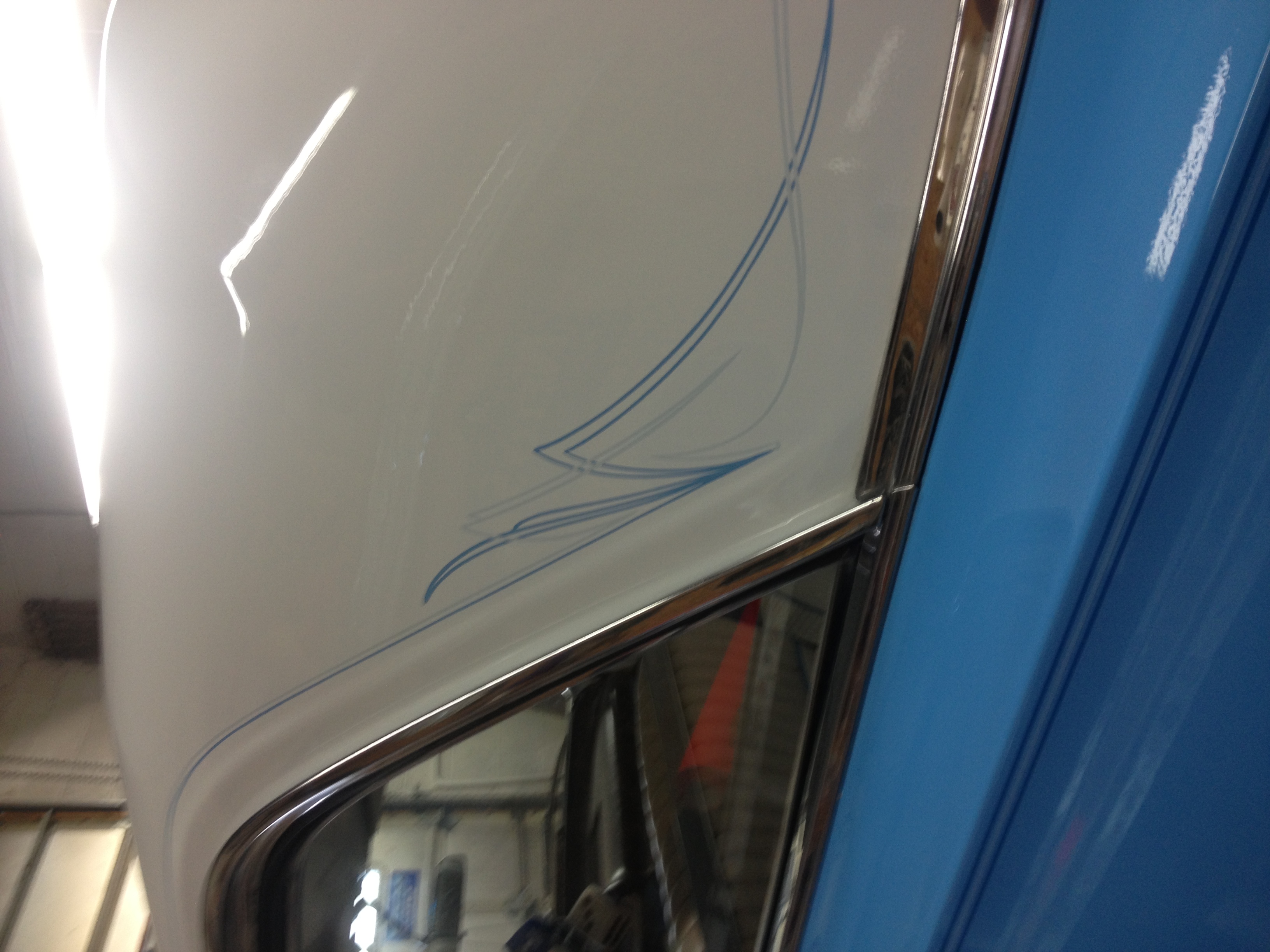 Close-up of hand-painted pinstripe detail on a car door