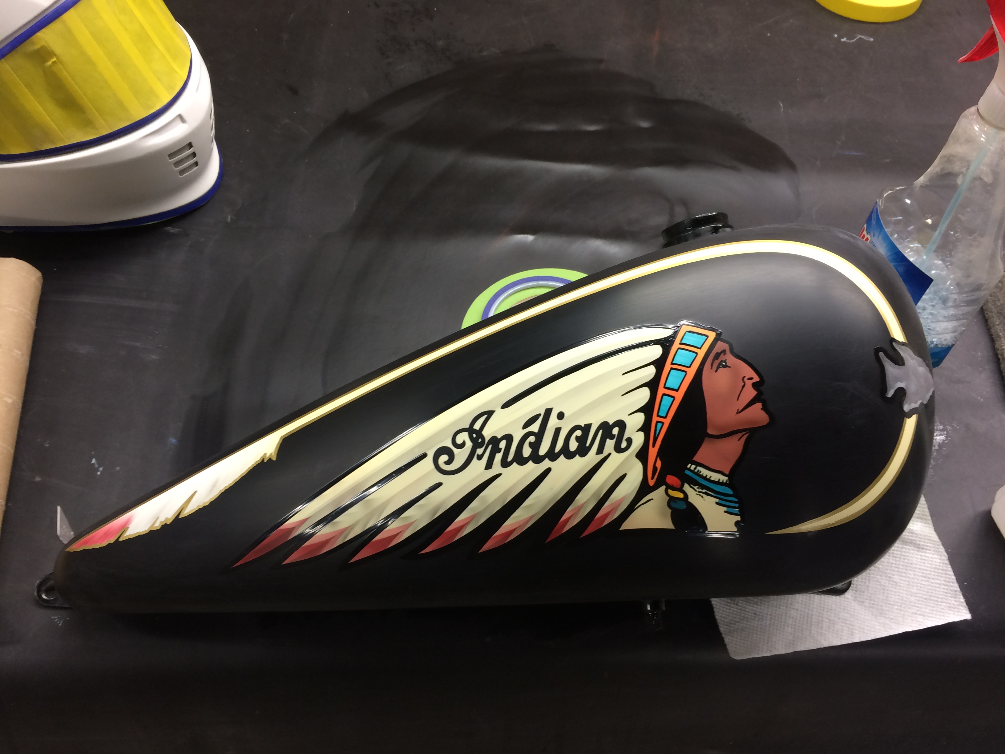 Hand-painted Indian motorcycle chief head graphic on a fuel tank