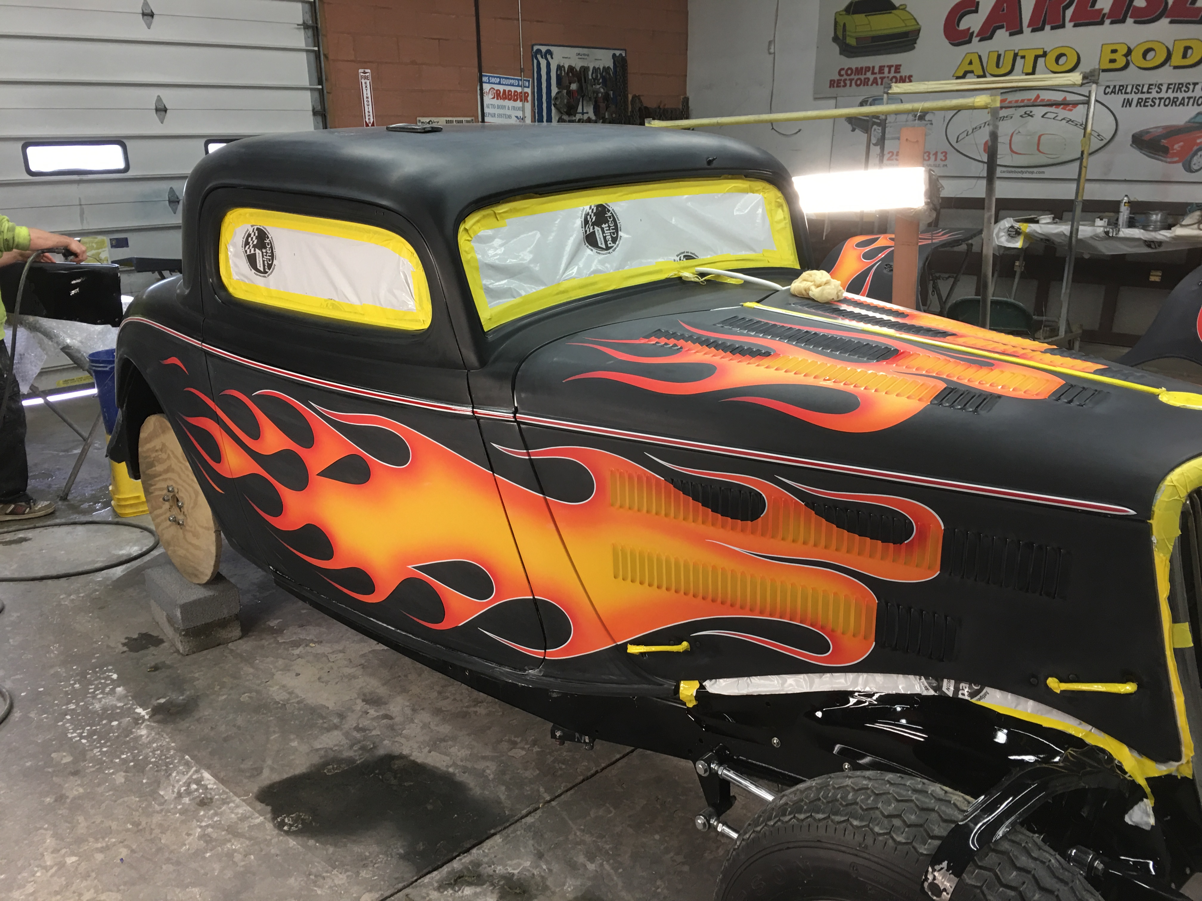 Hot rod coupe with custom black and orange flame paint job