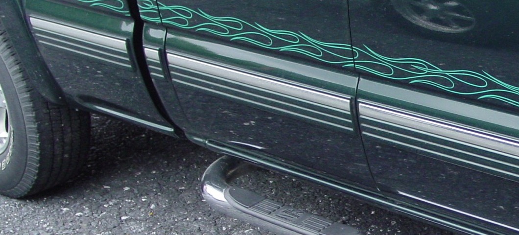 Hand-painted pinstripe linework along a vehicle rocker panel