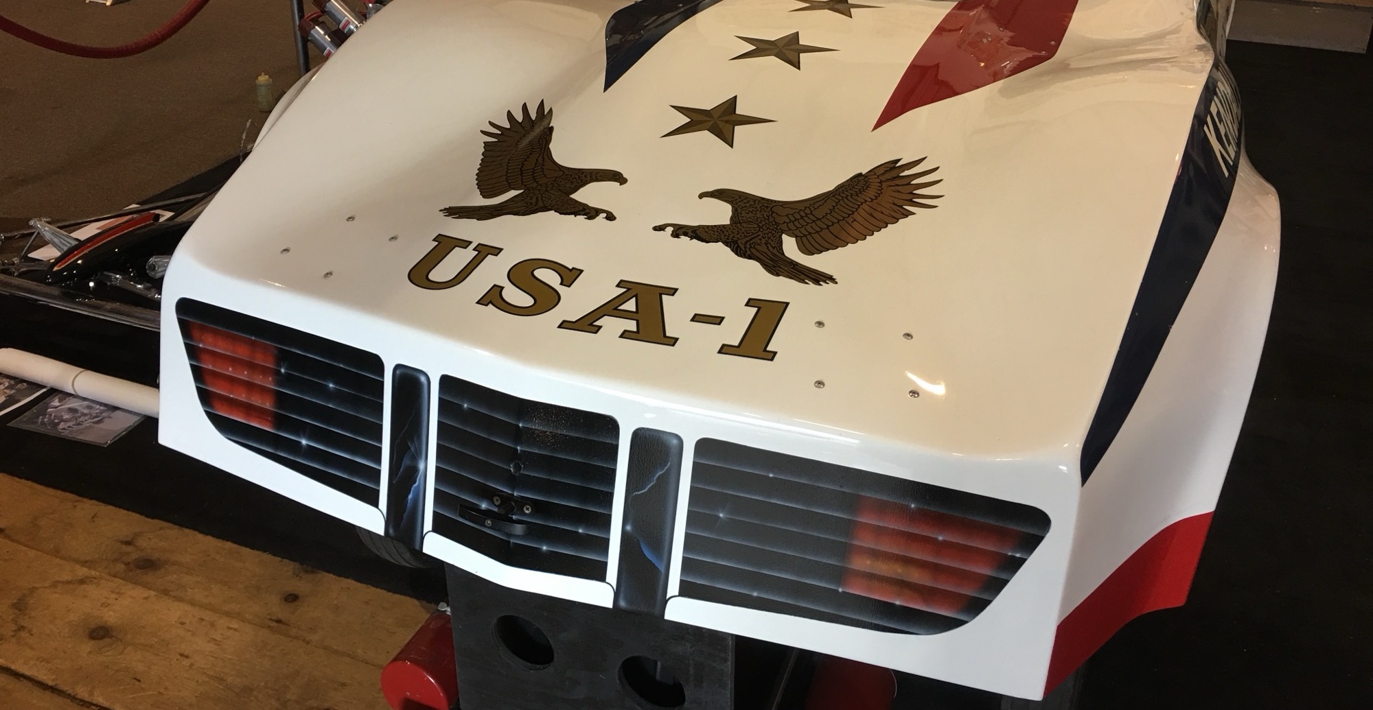 Custom painted eagle and star graphics on a race car body
