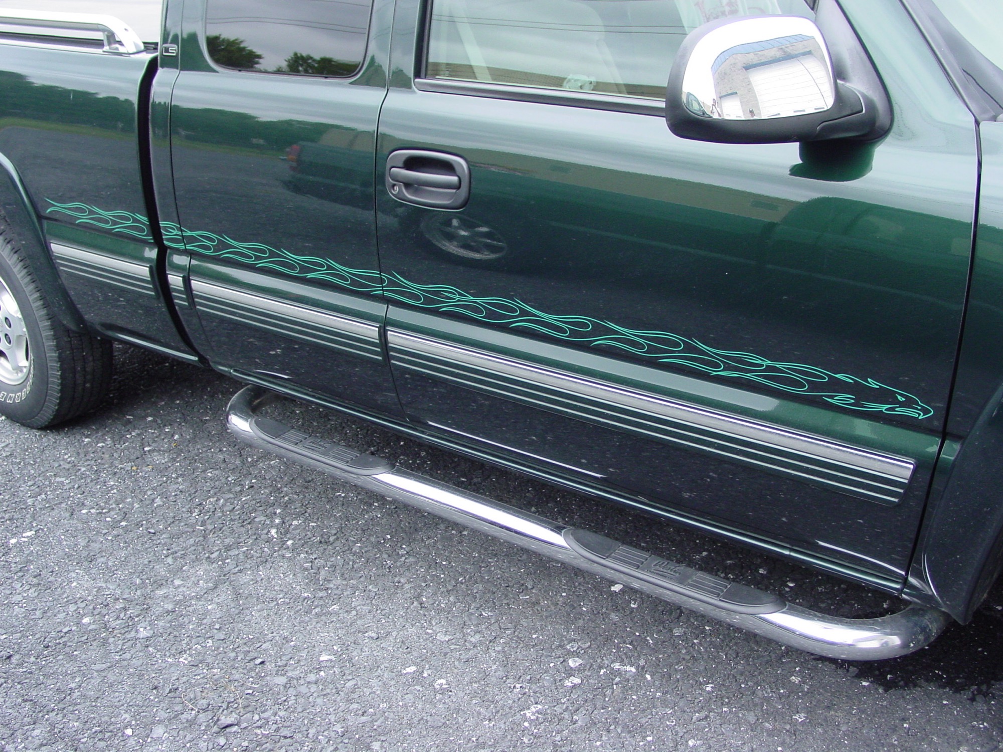 Hand-painted pinstriping running along a truck door panel