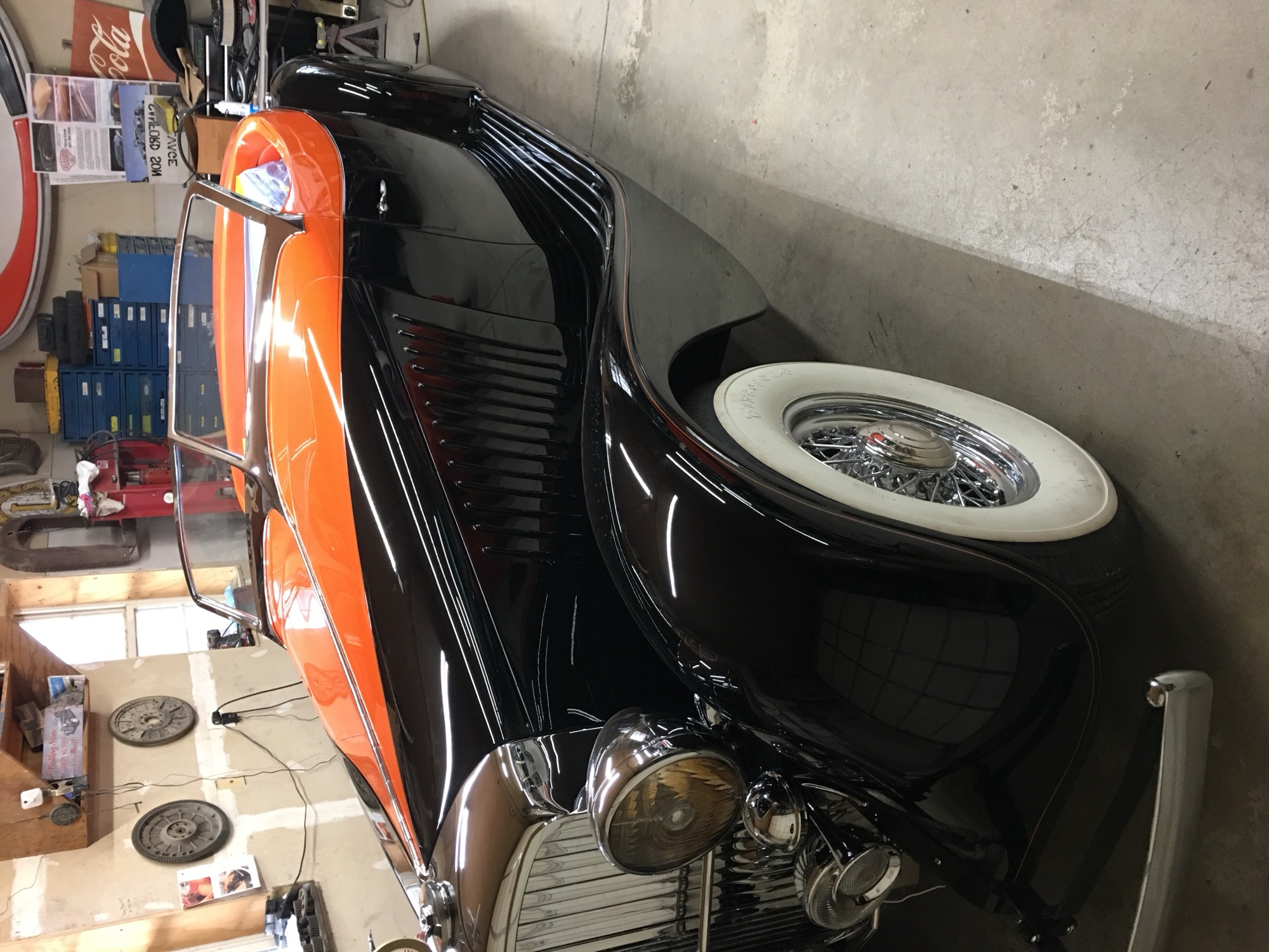 Finished black and orange custom paint on a classic roadster